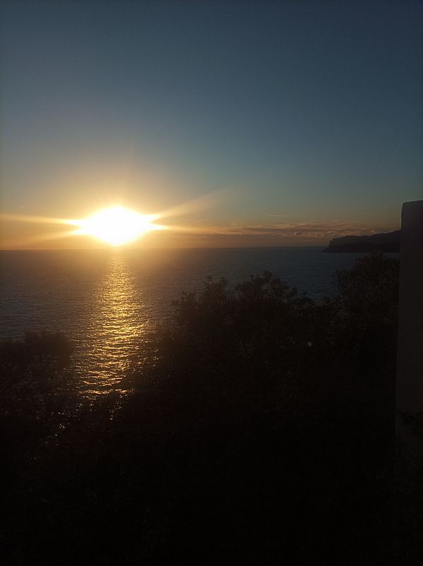 A stunning sunset over the ocean with vibrant colors reflecting on the water.