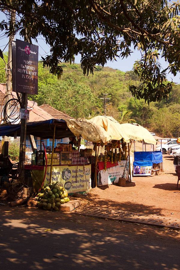 A vibrant street food stall in Goa, showcasing local cuisine and a lively atmosphere.