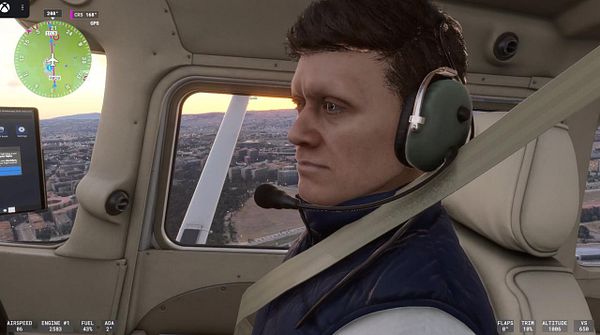 A pilot is seen in the cockpit of a flight simulator, focused on flying with a detailed view of the landscape outside.