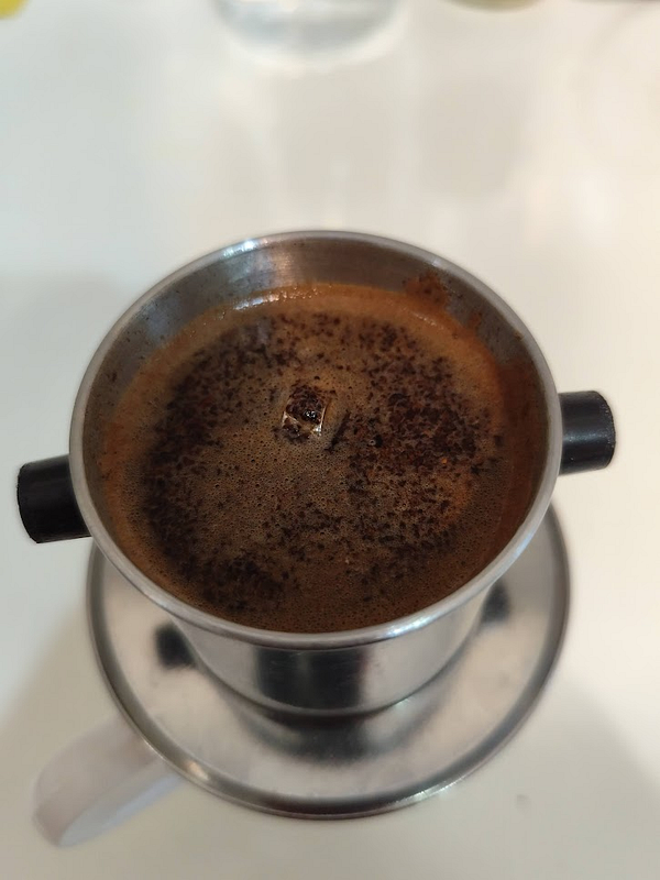 A close-up view of a traditional coffee filter with brewed coffee.