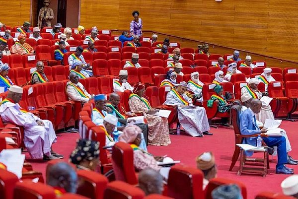 A gathering of members of the National Transitional Council of Mali in a formal setting.