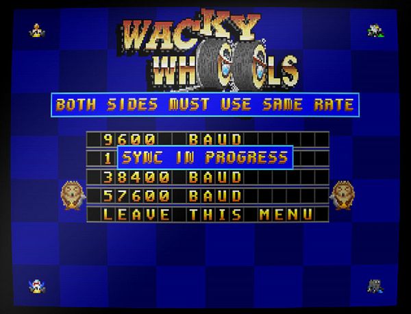 Top-down view of a retro-style racing game with colorful cars navigating a track on grassy terrain.