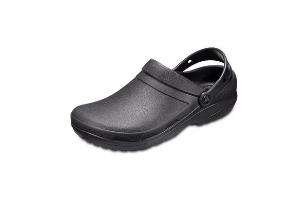 A pair of green Crocs Specialist II clogs displayed on a wooden floor alongside a white-tiled floor.