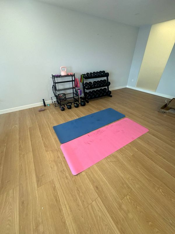 A home gym setup featuring exercise mats and weights.