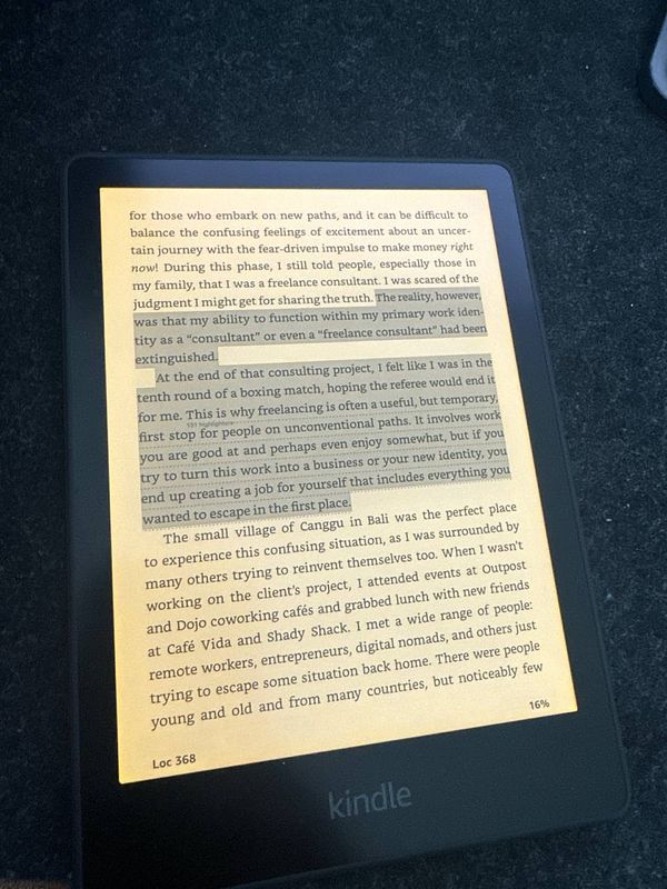 A Kindle e-reader displaying a passage from the book 'Good Work'.