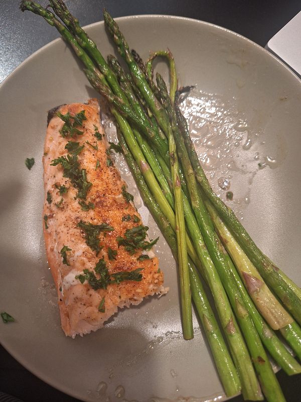 A plate featuring a portion of salmon and asparagus.