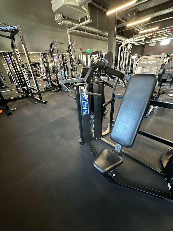 A well-equipped gym area featuring various strength training machines.