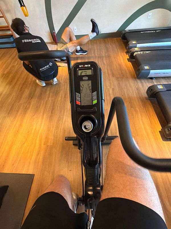 Portrait of two muscular men posing shirtless in a gym environment.