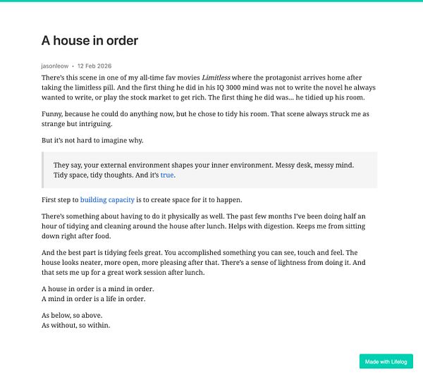 A modern living room featuring large windows with a cityscape view, a clean wooden floor, and neutral-toned furniture.