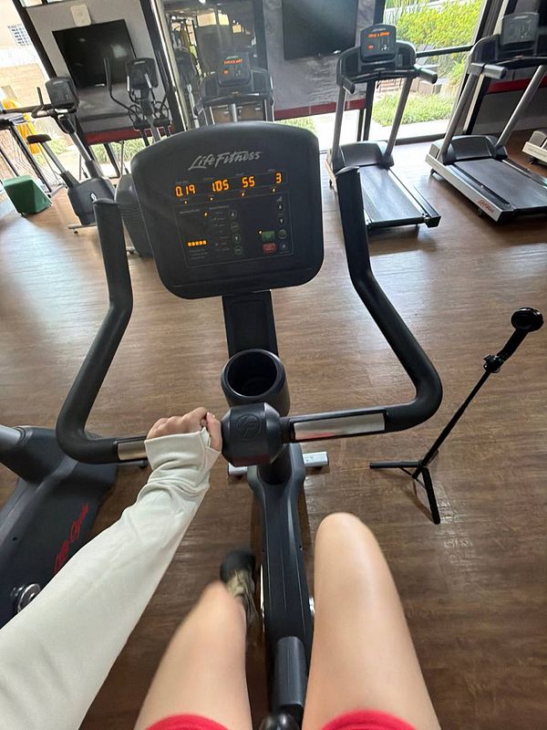 Black workout sports bra or crop top with the word 'SWEAT' printed on it in white.