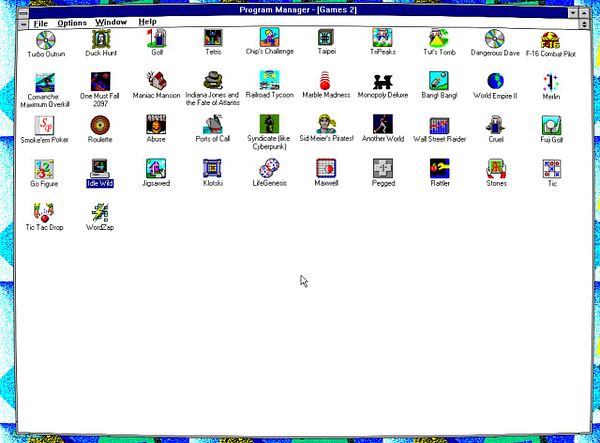 Screenshot of a Windows 3.1 desktop with a folder named 'GAMES' open showing icons of classic games and a startup screen of Wolfenstein 3D.