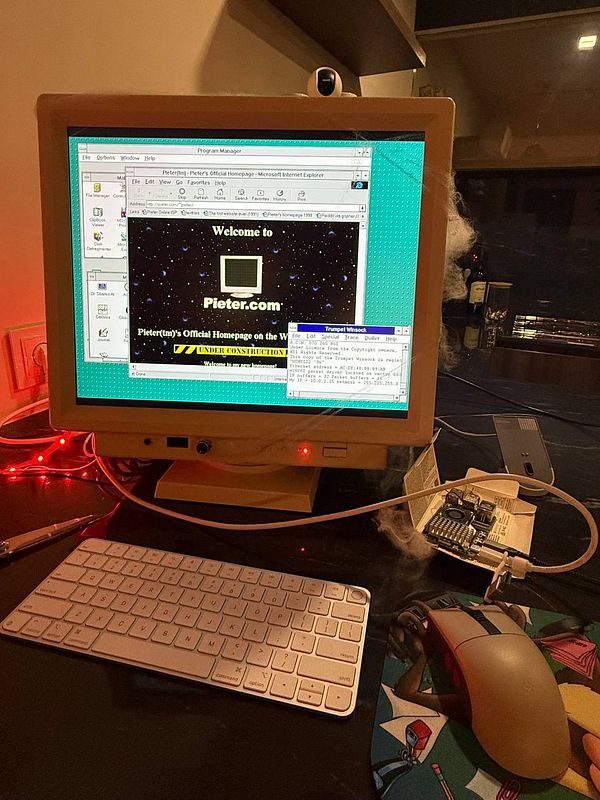 A retro computer setup displays the website Pieter.com on a Windows 3.11 interface.
