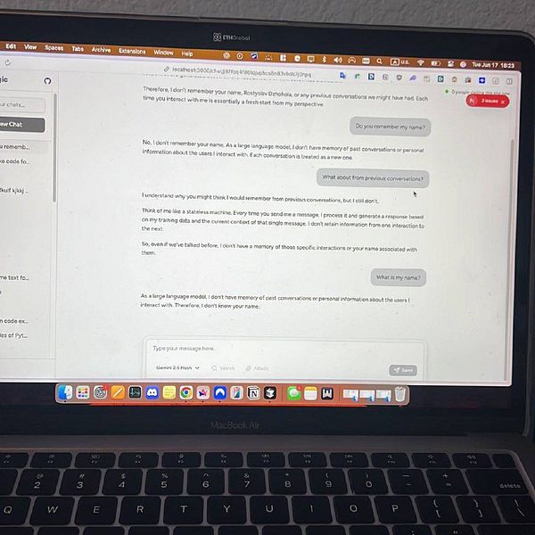 A conversation interface on a laptop screen discussing memory in AI interactions.