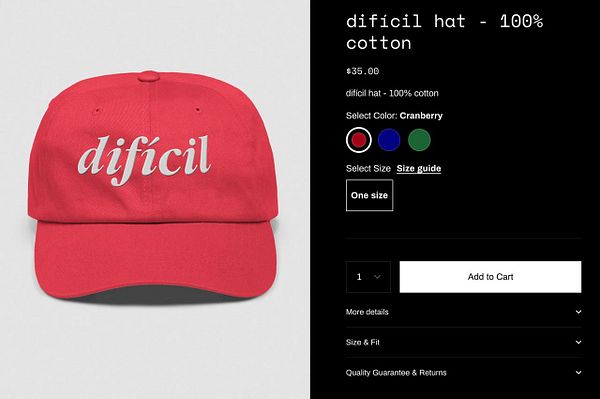 A red baseball cap featuring the word 'difícil' in a stylish font, displayed alongside product details for online purchase.