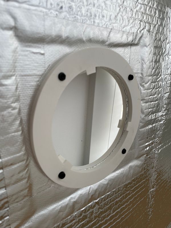 A window securely sealed with multiple layers of clear and opaque materials for DIY insulation.