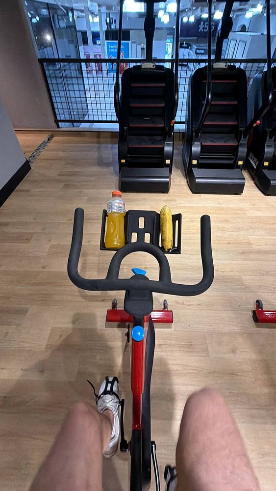 A well-lit gym interior with various exercise equipment including weight machines and free weights.