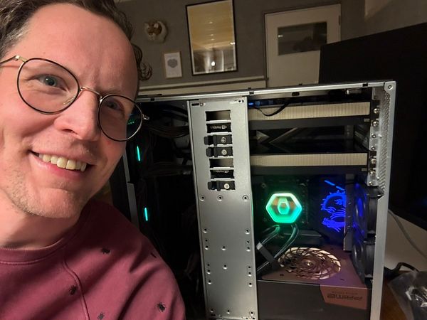 Two Nvidia RTX 6000 graphics cards installed inside a computer case, illuminated with colorful RGB lighting.