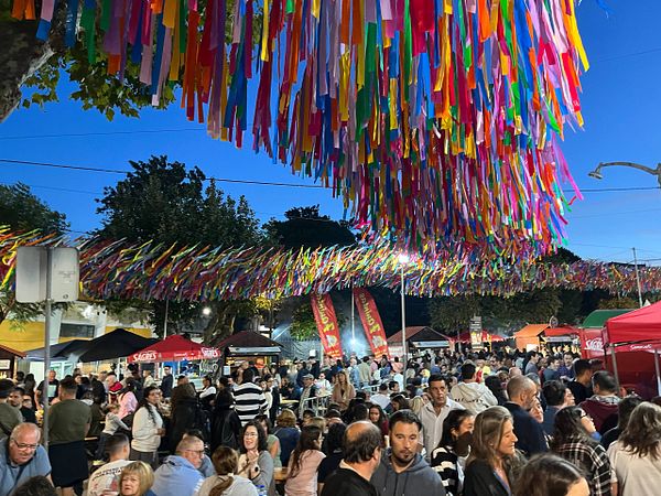 A vibrant soup festival scene filled with people enjoying the festivities under colorful decorations.