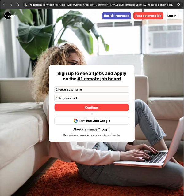 A user is interacting with a job board sign-up interface on a laptop while seated on a couch.