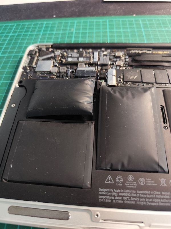 Close-up image of an open old MacBook Air 2015, focusing on the keyboard and trackpad.