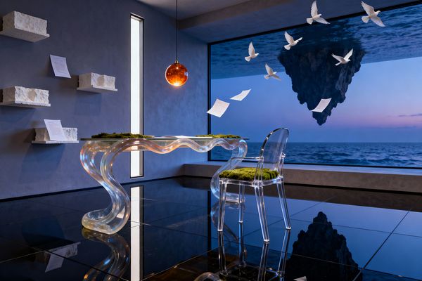 Surreal home office featuring an iridescent wavy lucite desk and a clear acrylic chair with a moss seat, set on glossy black tile flooring. Deep blue plaster walls host rough white stone shelves with loose papers and a narrow vertical window, while an amber glass globe pendant glows overhead. A wall-wide picture window reveals a calm ocean at dusk with a hovering rock island, white birds in flight, and drifting pages, blending interior and seascape.