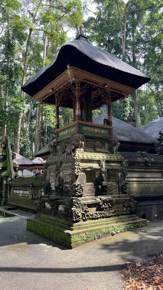 A traditional Balinese temple structure surrounded by lush greenery in Ubud.