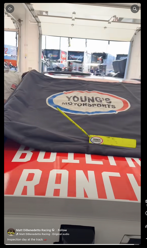 A cover featuring a "Young's Motorsports" logo laid over a NASCAR race car inside a garage area at a race track.