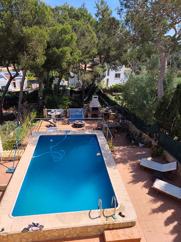 A sunny outdoor terrace with sun beds and a neat arrangement suitable for summer relaxation.