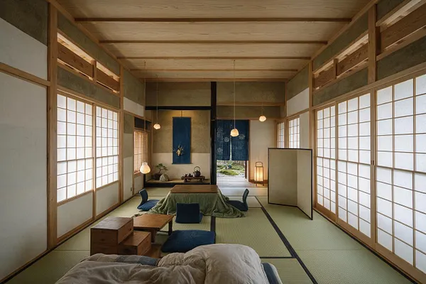 A Japanese Zen master bedroom with tatami mat flooring, shoji paper screens on both sides, and warm wood framing throughout. The room includes low cushions and a low table with dark blue accents, creating a calm, minimalist atmosphere.