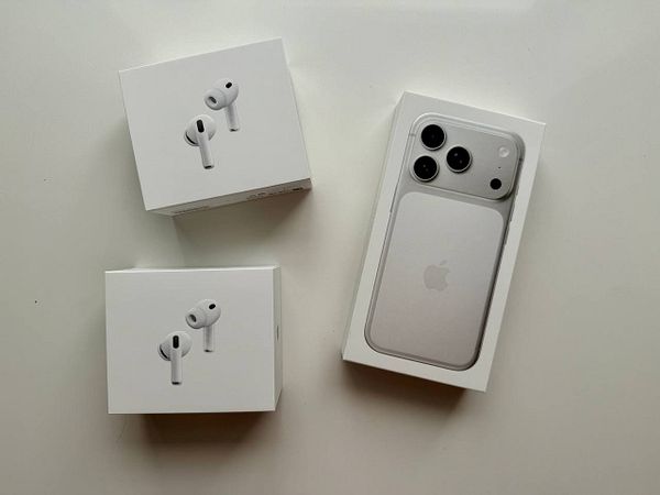 The image features a new iPhone and two boxes of AirPods on a white surface.
