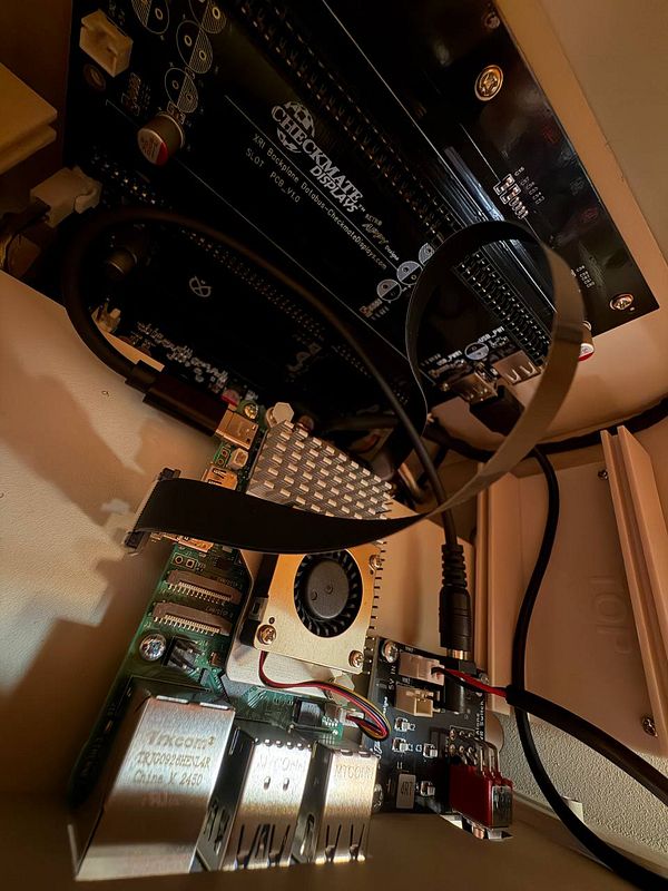 The image captures the internal components of a retro display housing a Raspberry Pi and associated circuitry.