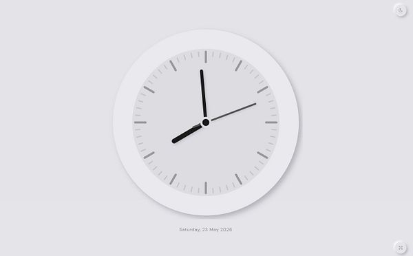 A modern digital flap clock with bold orange and white styling is displayed on a dark background.