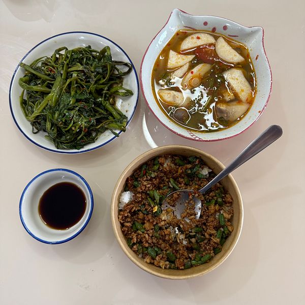 A delicious spread of Thai dishes is presented on a light-colored table.