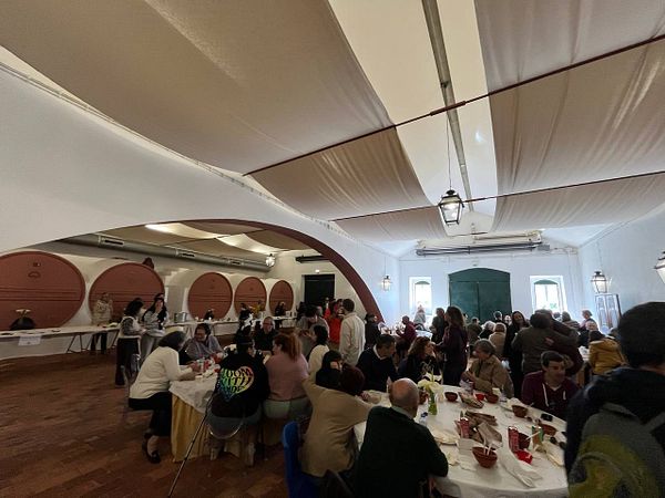 A large outdoor crowd enjoys a festival with a prominent banner advertising the "International Go Soup Festival."
