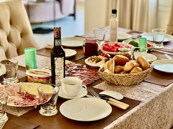A beautifully arranged breakfast table featuring a variety of food items.