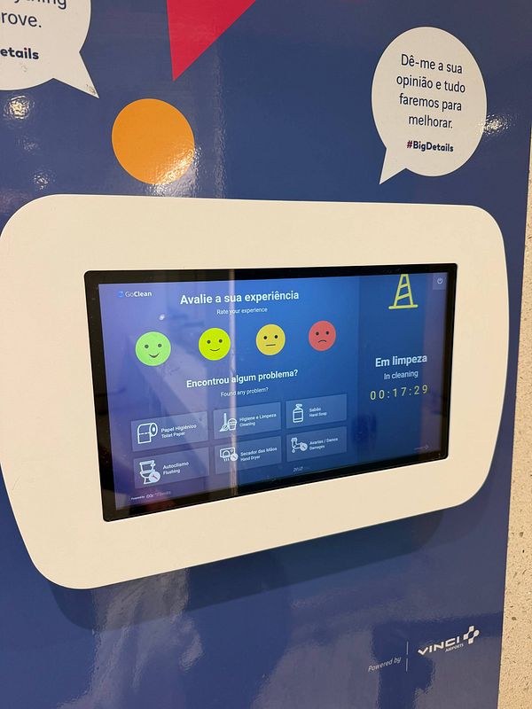 Photo of a closed and blocked toilet in Lisbon Airport arrivals with a cleaning notice sign preventing use for 17 minutes.