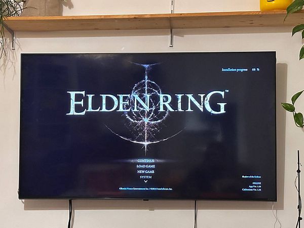 The image displays the main menu of the game Elden Ring on a television screen.