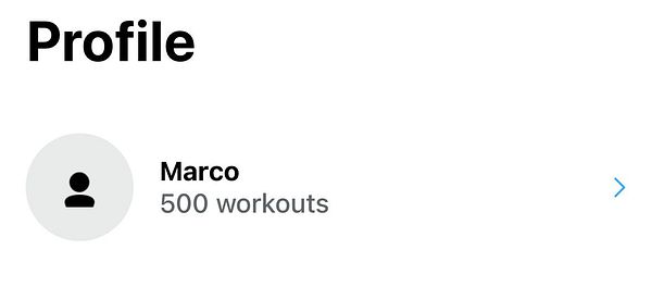 Photo of a muscular person lifting gym weights wearing a black hoodie with 'NEW YORK 1996' printed.