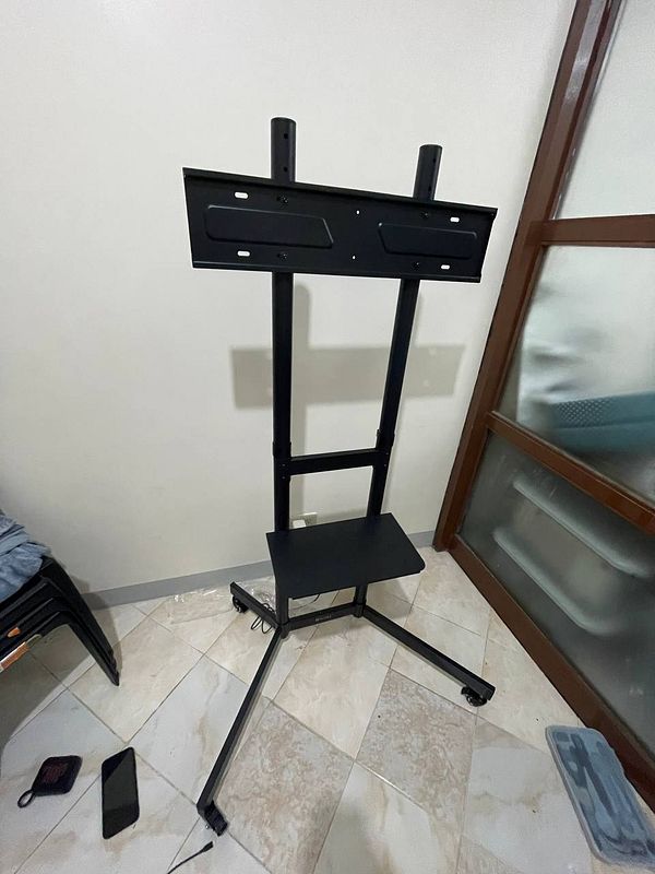 Photo of a TV wall mount bracket attached to a wooden wall indoors.