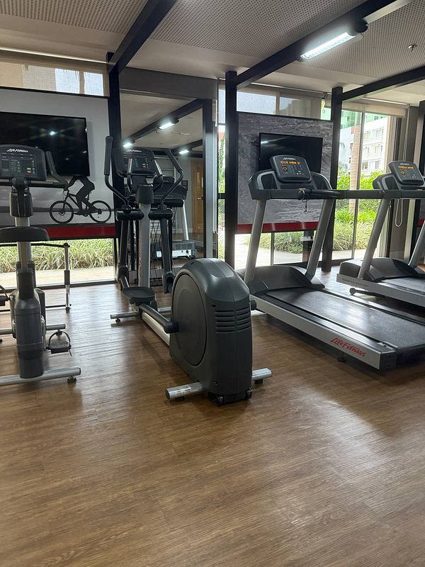 A well-equipped gym area featuring various exercise machines.