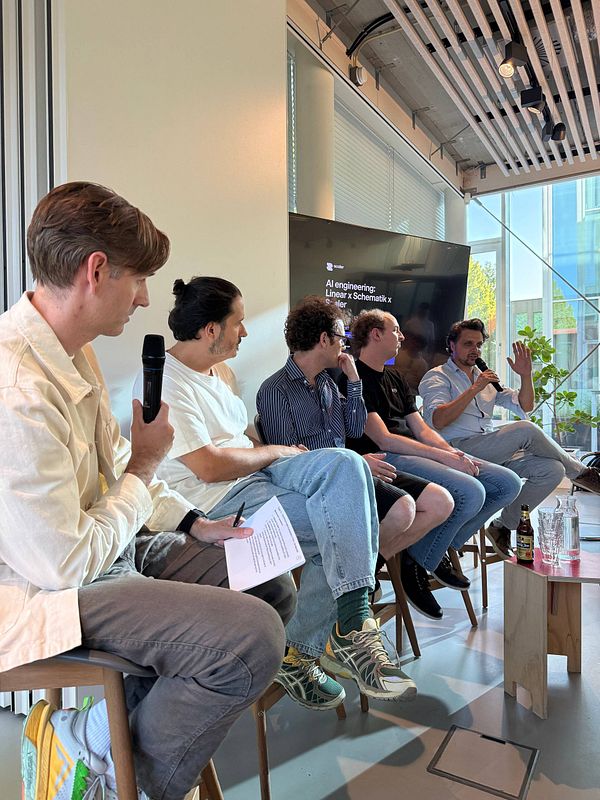 Colorful embroidered dragon design on a shirt at an AI meetup event.