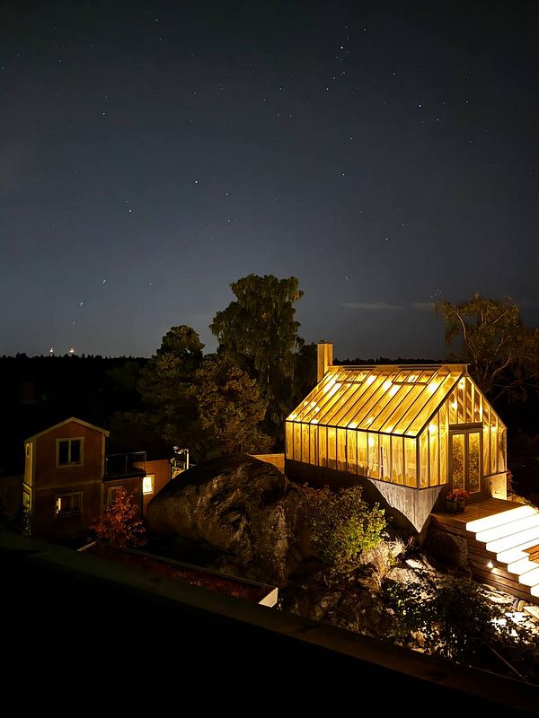 A photo of a sauna stove with glowing sauna stones on top inside a wooden sauna room.