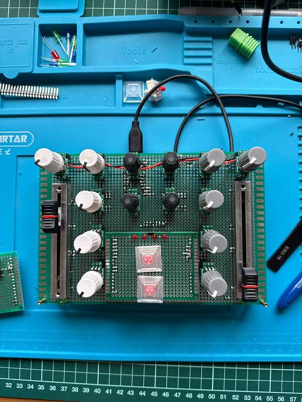 Close-up image of a custom-made MIDI controller prototype with sliders, knobs, and a wooden frame designed for mixer control.