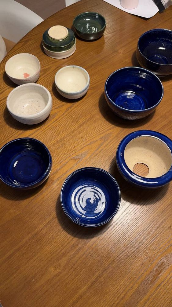 Photo of a vertical kiln or ceramic firing setup with stacked ceramic pieces inside.