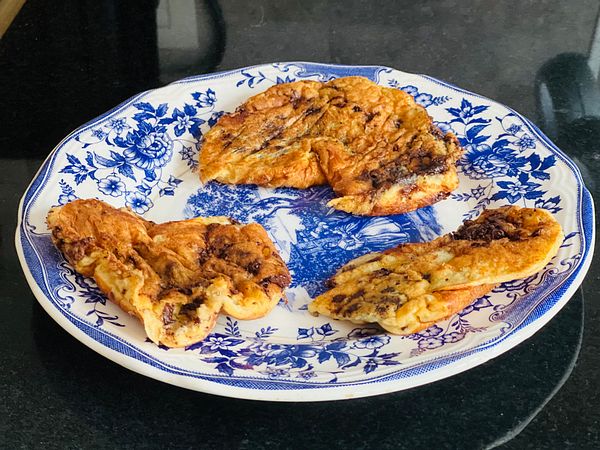 A plate of oatmeal pancakes with a rustic design.
