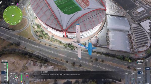 A Cessna aircraft is flying over a stadium in Lisbon, with flight data displayed on the screen.