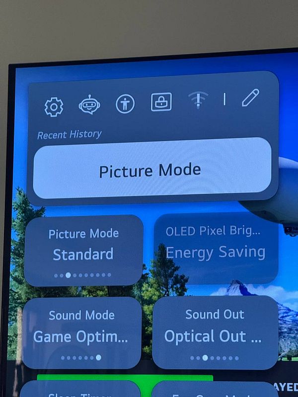 The image displays a TV screen showing the settings menu for picture and sound modes.