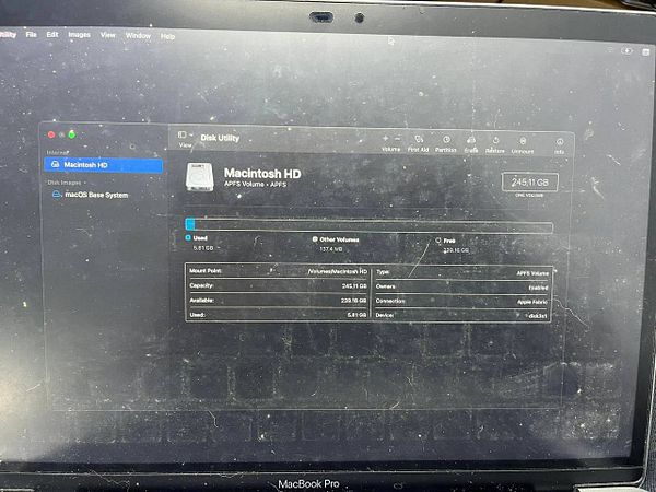 Close-up of a Mac keyboard with a user's finger on the 'shift' key, highlighting specific keys for Mac data recovery procedures.