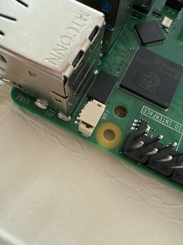 A close-up view of a Raspberry Pi board highlighting its USB ports and a nearby component.