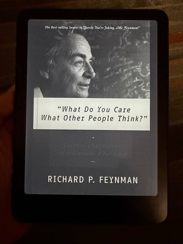 The image displays the cover of Richard Feynman's book 'What Do You Care What Other People Think?' on an e-reader.